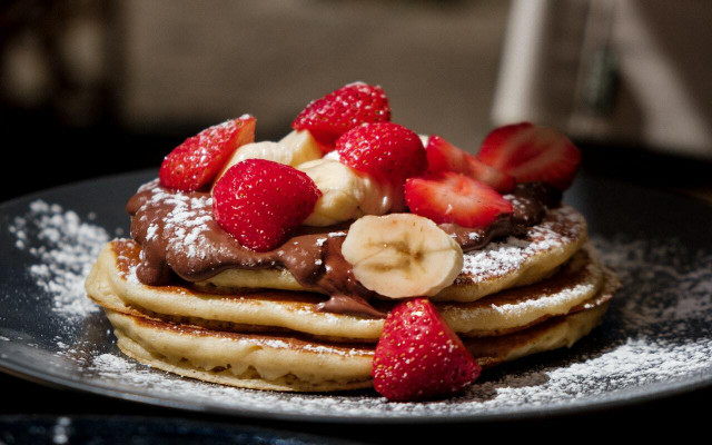 Top your oat milk pancakes with homemade Nutella and organic fruit. 