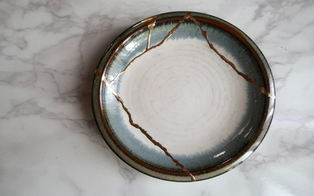 Glueing porcelain back together and brushing the cracks with gold is known as kintsugi. 