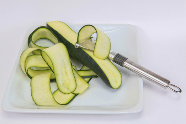 TIP: Use a peeler to get your zucchini fine and even for this pickled zucchini recipe. 