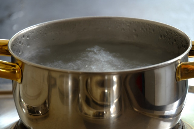 Use a pot of boiling water to defrost your fridge quickly.