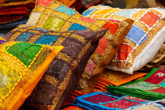 You can find a new home for your old duvet covers by turning them into funky cushions.