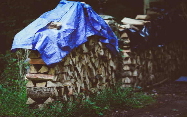 Covering firewood with a tarp should only be used as a temporary solution for bad weather. 