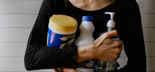 woman holding disinfectant