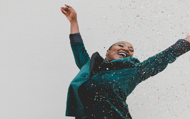 Mimicking throwing confetti is one of the six movements of the joy workout. 