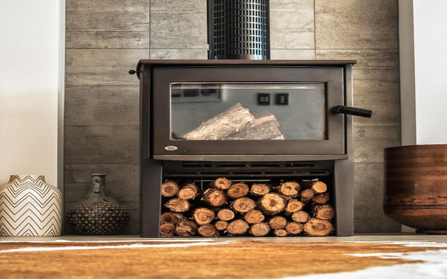 Even if your wood-burning stove has storage space for firewood, you're best off keeping wood outside. 