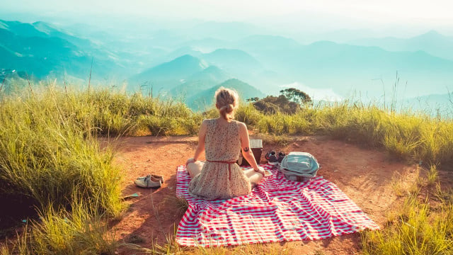 Becoming minimalist woman mountain picnic