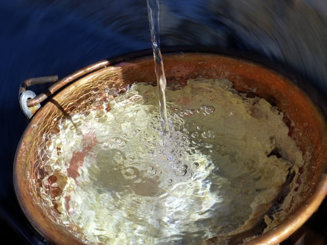 Start by scrubbing copper pans and pots with soap and water, then rinse them.