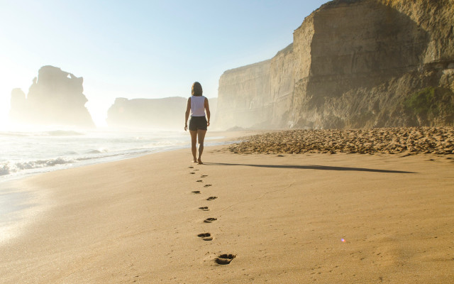 Self-improvement think for yourself woman walking seashore