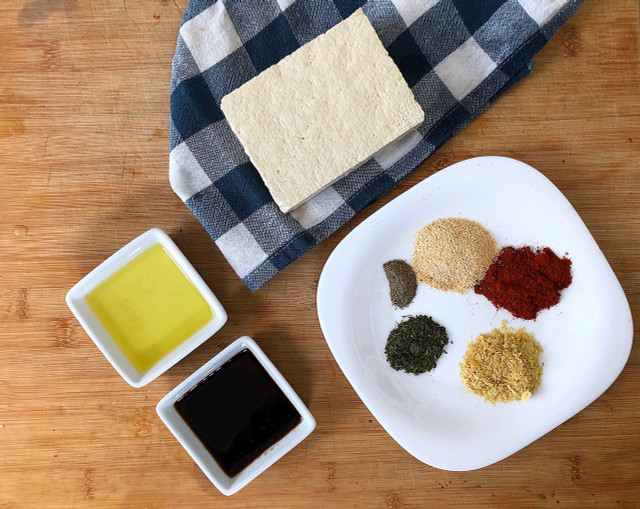 Use a clean kitchen towel or table cloth to press the tofu.